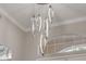Modern chandelier with a unique design hangs from the ceiling in the home interior at 133 Via Capri, New Smyrna Beach, FL 32169