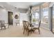 Elegant dining room with modern chandelier, bright windows and stylish furnishings at 133 Via Capri, New Smyrna Beach, FL 32169