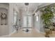 Spacious foyer boasts a decorative mirror, chandelier, and glass-paneled double doors at 133 Via Capri, New Smyrna Beach, FL 32169