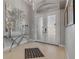 Elegant foyer with decorative mirror and glass table adjacent to the decorative front door at 133 Via Capri, New Smyrna Beach, FL 32169