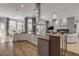 Spacious open-concept kitchen with a large island, sleek white cabinets, and floor-to-ceiling windows overlooking the pool at 133 Via Capri, New Smyrna Beach, FL 32169