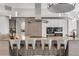 Kitchen island with seating, stainless hood and appliances, and sleek modern design at 133 Via Capri, New Smyrna Beach, FL 32169