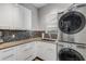 A well-organized laundry room with modern machines and stylish backsplash at 133 Via Capri, New Smyrna Beach, FL 32169