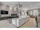 Bright and airy living room with a large sectional sofa, modern decor, and a view of the outdoor area at 133 Via Capri, New Smyrna Beach, FL 32169