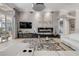 Bright living room with modern furniture, stylish decor, fireplace, and expansive glass doors leading to outdoor space at 133 Via Capri, New Smyrna Beach, FL 32169
