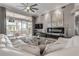 Stylish living room featuring a comfortable white sofa, modern decor, and large glass doors opening to the patio at 133 Via Capri, New Smyrna Beach, FL 32169