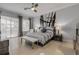 Main bedroom features a king bed, gray and white striped bedding, a neutral palette and plenty of light at 133 Via Capri, New Smyrna Beach, FL 32169