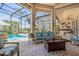 Comfortable outdoor living area with plush seating, a fire pit, and views of the pool and canal at 133 Via Capri, New Smyrna Beach, FL 32169