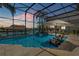 Stunning screened-in pool area with outdoor seating and beautiful views of the canal at 133 Via Capri, New Smyrna Beach, FL 32169