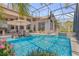 Exterior showing a screened pool with water features, an in-pool seating area, and an outdoor seating area at 133 Via Capri, New Smyrna Beach, FL 32169