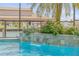A beautiful pool feature showcasing a stone waterfall and manicured garden, overlooking the waterfront at 133 Via Capri, New Smyrna Beach, FL 32169