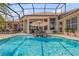 Beautiful pool with in-pool seating and scenic views of the surrounding outdoor space at 133 Via Capri, New Smyrna Beach, FL 32169