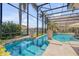 Screened pool area showcasing a built-in jacuzzi, poolside plants, and seating on the water, with access to the boat dock at 133 Via Capri, New Smyrna Beach, FL 32169