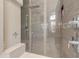 This shower features neutral tile, built-in bench, rainfall shower head, and handheld shower at 133 Via Capri, New Smyrna Beach, FL 32169