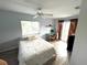 Cozy bedroom with wood-look flooring, sliding glass doors, ceiling fan, and a light blue wall at 1422 N Atlantic Ave, New Smyrna Beach, FL 32169