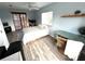 A bright bedroom features a ceiling fan, desk, wood-look flooring, and sliding glass doors at 1422 N Atlantic Ave, New Smyrna Beach, FL 32169