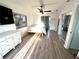 Sunny bedroom offers natural light, closet, hard-surface flooring, ceiling fan, and a dresser at 1422 N Atlantic Ave, New Smyrna Beach, FL 32169