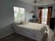Comfortable bedroom offers natural light, wood-look flooring, ceiling fan, and a workspace at 1422 N Atlantic Ave, New Smyrna Beach, FL 32169