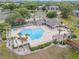 Aerial view of the community pool, adjacent seating and grilling area and wooden bridge at 160 Reserve Cir # 204, Oviedo, FL 32765
