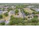 An aerial view of a building surrounded by lush trees, parking areas, and a nearby recreational area at 160 Reserve Cir # 204, Oviedo, FL 32765