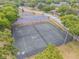 Aerial view of community tennis court, surrounded by mature trees and well-maintained landscaping at 160 Reserve Cir # 204, Oviedo, FL 32765