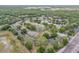 Community aerial showcasing lush greenery, buildings, parking, tennis courts, and the surrounding landscape at 160 Reserve Cir # 204, Oviedo, FL 32765