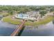 Aerial view of community pool and spa area next to the bridge and small lake at 160 Reserve Cir # 204, Oviedo, FL 32765