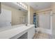 Bright bathroom with a white vanity, large mirror, and shower-tub combination with a curtain at 160 Reserve Cir # 204, Oviedo, FL 32765
