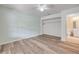 Bedroom showcasing wood-look floors, closet, and easy access to an adjacent bathroom creating an open layout at 160 Reserve Cir # 204, Oviedo, FL 32765