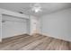 Bright bedroom with modern flooring, closet, ceiling fan creating an open layout to the door and closet at 160 Reserve Cir # 204, Oviedo, FL 32765