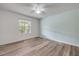 Cozy bedroom featuring wood-look floors, a ceiling fan, and a window that invites natural light and fresh air at 160 Reserve Cir # 204, Oviedo, FL 32765