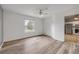 Bright bedroom with wood floors, a ceiling fan, and a window overlooking the neighborhood at 160 Reserve Cir # 204, Oviedo, FL 32765