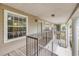 Exterior view of covered walkway featuring muted siding, wooden deck, and decorative pillars and railings at 160 Reserve Cir # 204, Oviedo, FL 32765