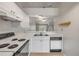 Bright kitchen with white cabinets, countertops, and appliances, featuring a double sink at 160 Reserve Cir # 204, Oviedo, FL 32765