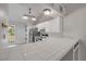 Kitchen with white cabinetry, stainless steel appliances, and bar seating at 160 Reserve Cir # 204, Oviedo, FL 32765