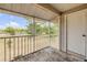 Enclosed outdoor patio area with a wooden floor, offering a scenic view of the surrounding green space at 160 Reserve Cir # 204, Oviedo, FL 32765