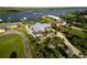 Aerial view of home with circular driveway, lush landscaping, and well-manicured lawn in a tropical setting at 1601 S Riverside Dr, Edgewater, FL 32132
