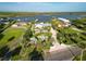 An aerial view of a waterfront home with lush landscaping, a well-manicured lawn and boat dock at 1601 S Riverside Dr, Edgewater, FL 32132