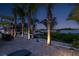 Waterfront backyard with patio seating, waterfront view and palm trees, creating a relaxing outdoor oasis at 1601 S Riverside Dr, Edgewater, FL 32132