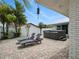 The brick paved patio has lounge chairs and a hot tub, surrounded by mature landscaping at 1601 S Riverside Dr, Edgewater, FL 32132