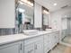 Bright bathroom featuring double sinks with white countertops and modern fixtures at 1601 S Riverside Dr, Edgewater, FL 32132