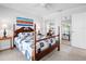 Charming bedroom featuring a four-poster bed, tile floors and mirrored closet at 1601 S Riverside Dr, Edgewater, FL 32132
