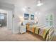 Bright bedroom with a colorful quilt, shutters, and neutral walls at 1601 S Riverside Dr, Edgewater, FL 32132