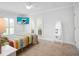 Bedroom with TV and colorful quilt featuring neutral walls and flooring at 1601 S Riverside Dr, Edgewater, FL 32132