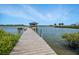 A wooden dock stretches out into the water, offering a tranquil escape and scenic views at 1601 S Riverside Dr, Edgewater, FL 32132