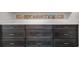 Dark brown wooden cabinet drawers under a white countertop, complemented by decorative, colorful tile art at 1601 S Riverside Dr, Edgewater, FL 32132