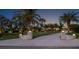 Long driveway leading up to the stunning property with manicured lawn and a variety of palm trees at 1601 S Riverside Dr, Edgewater, FL 32132