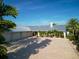Aerial view of a white single-story home with a long circular driveway, luscious trees, and a metal roof at 1601 S Riverside Dr, Edgewater, FL 32132