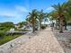 Beautiful home featuring well-manicured landscaping with palm trees and a scenic walkway at 1601 S Riverside Dr, Edgewater, FL 32132