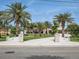 Stunning waterfront home featuring mature palms and a decorative, patterned driveway at 1601 S Riverside Dr, Edgewater, FL 32132